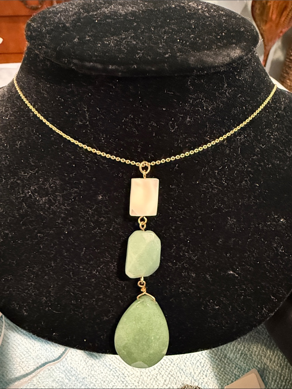 Beautiful green toned stones on long adjustable gold chain